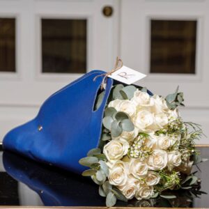 Bouquet with the Leather bag with fresh big roses